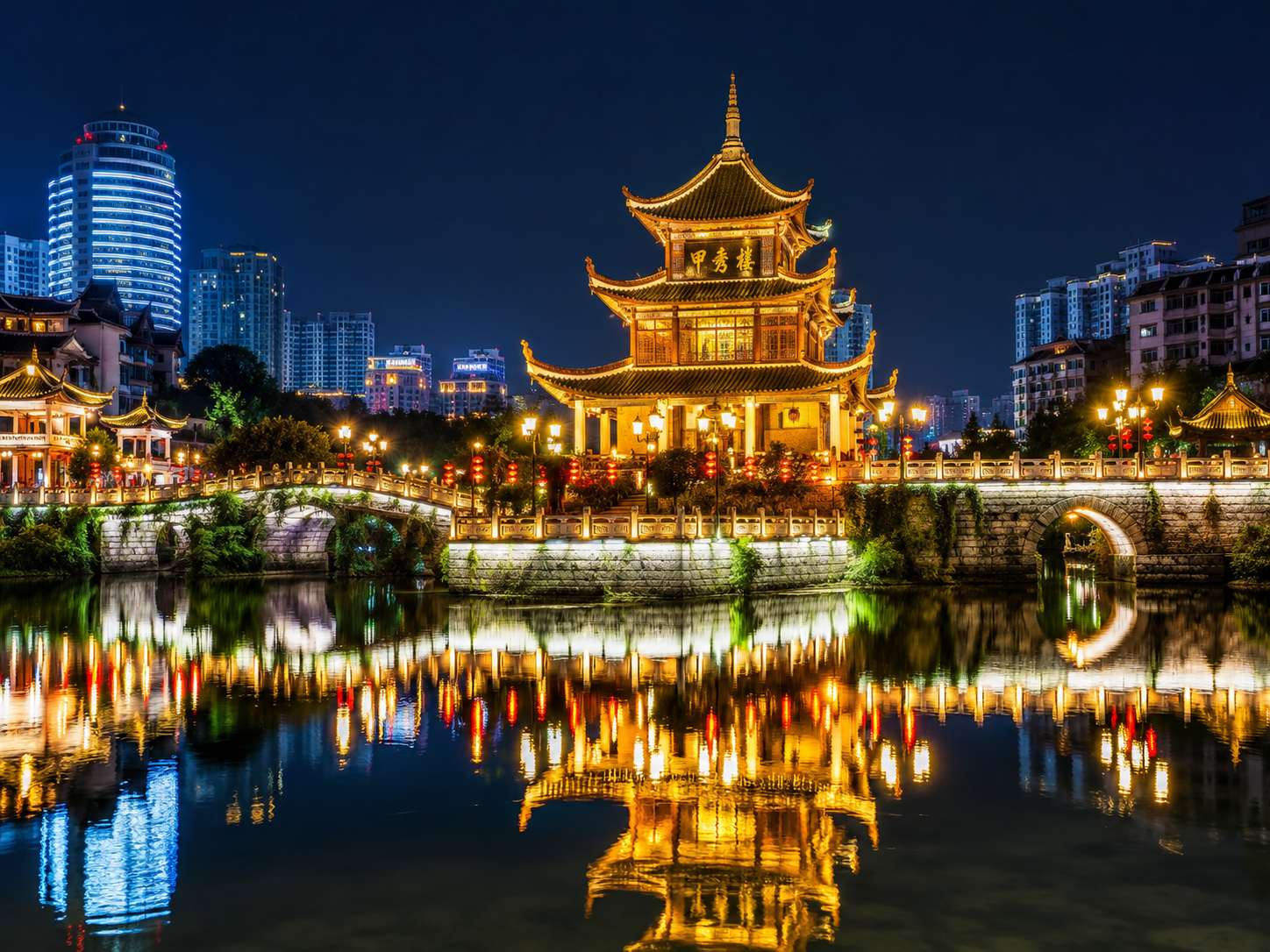 Jiaxiu Tower illuminated at night in Guiyang